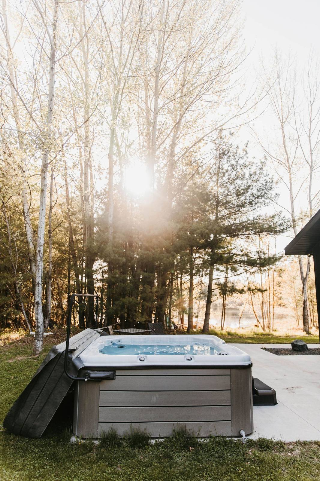 Outdoor hot tub in the woods at Cornerstone Cabin